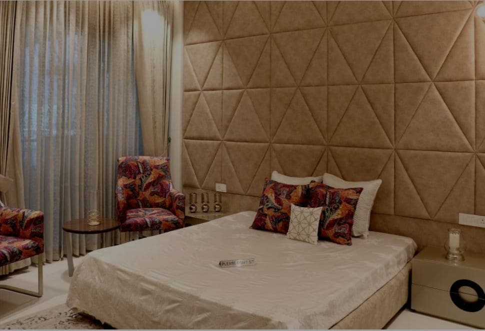 Guest bedroom with upholstered headboard in Zirakpur flat