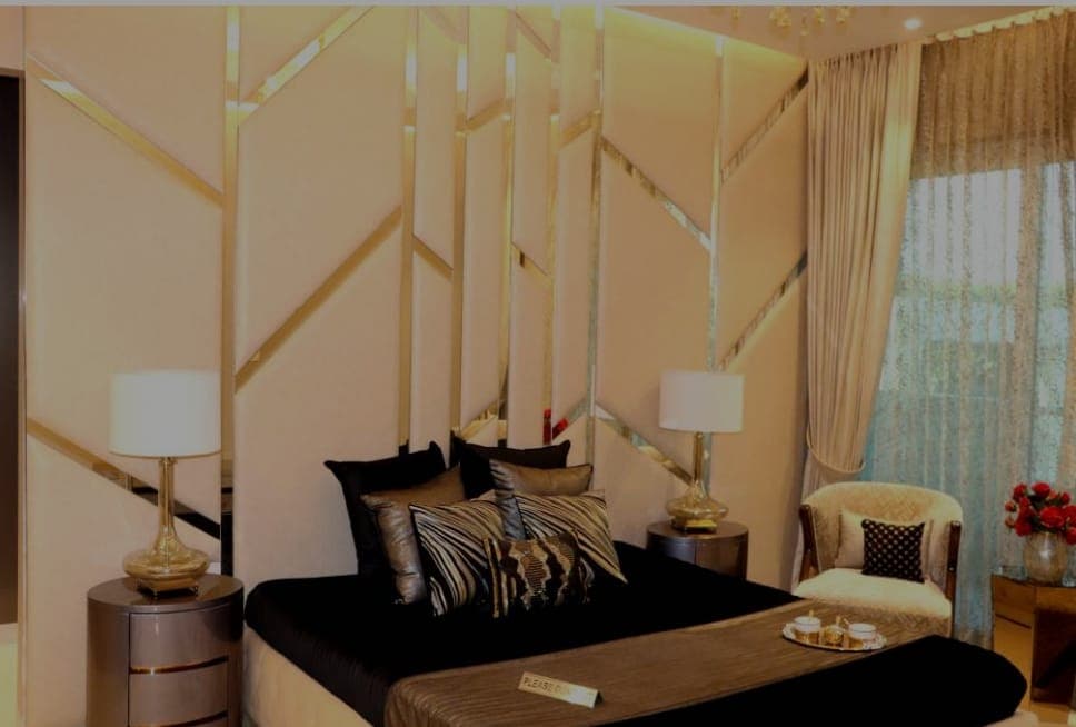 Master bedroom with gold accent wall in Zirakpur property