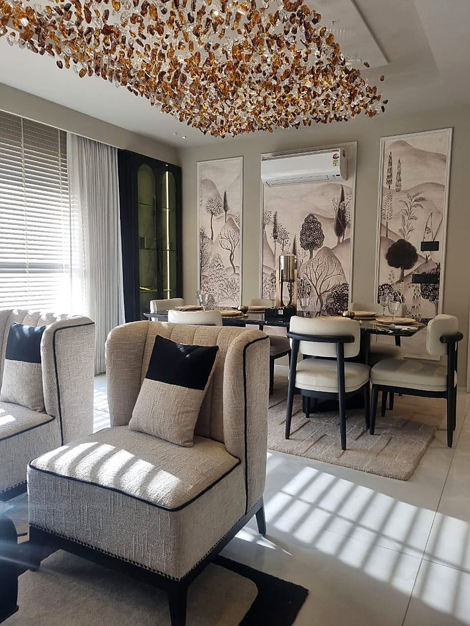 Open-plan living and dining area with artistic wall panels in Zirakpur luxury flat