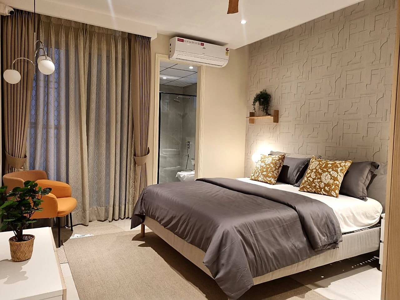 Bedroom with 3D textured wall panel and en-suite bathroom in Zirakpur ultra luxury flat